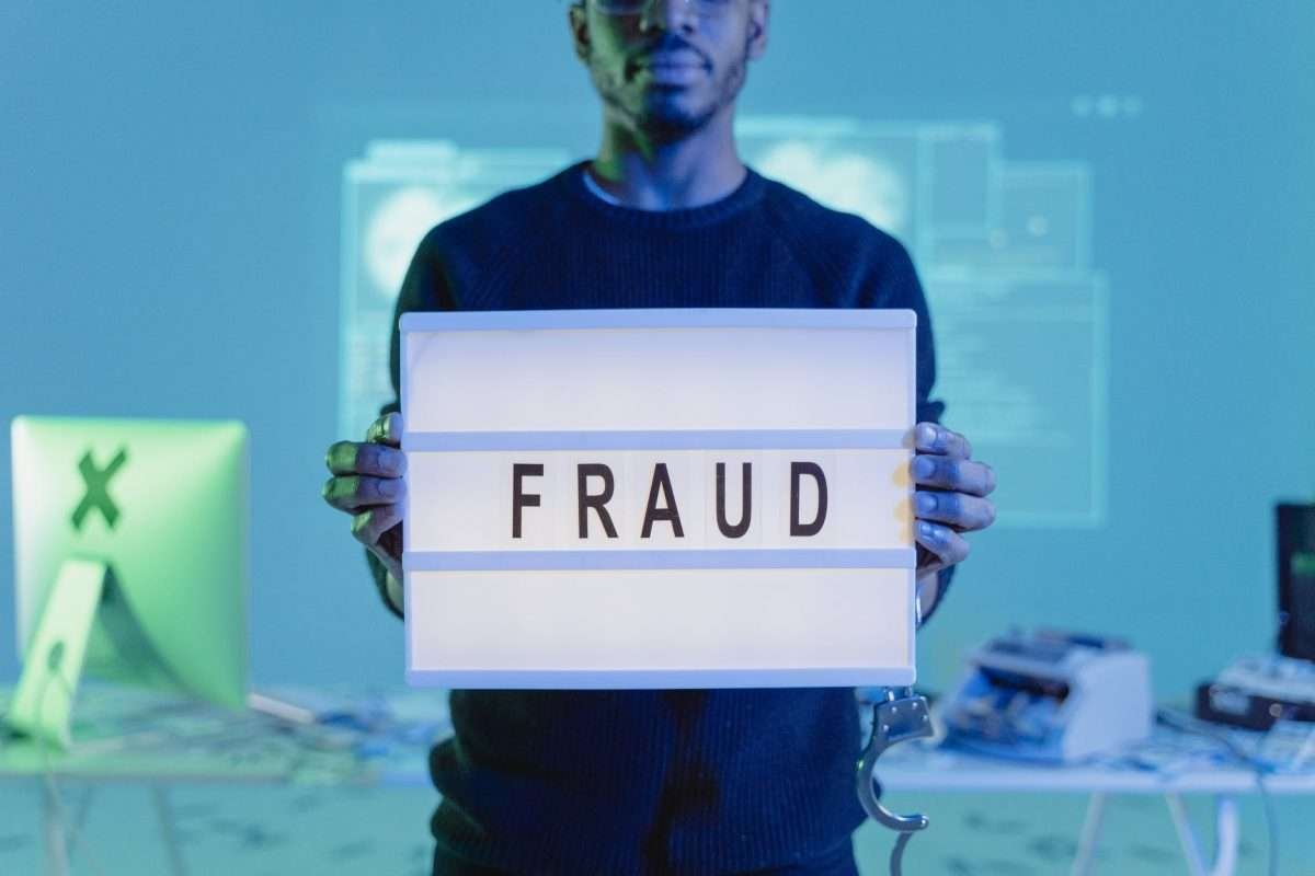 man with fraud sign