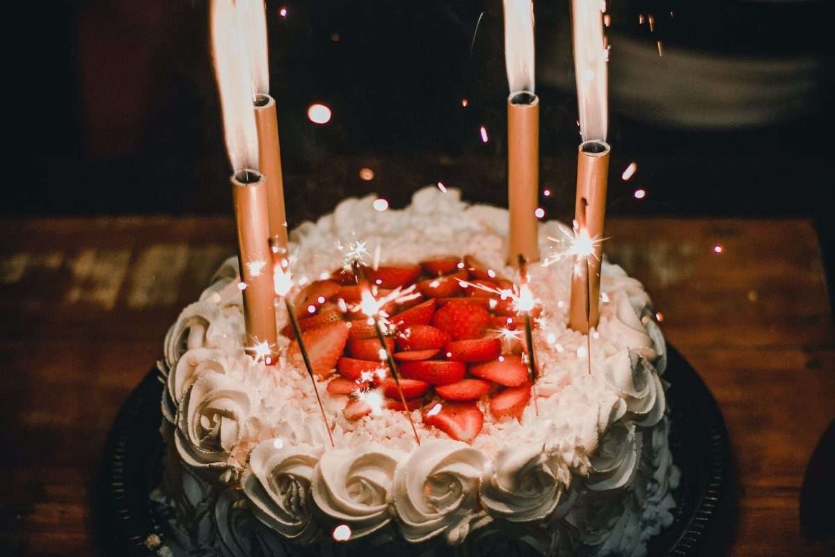 lighted candles on an elegant looking cake
